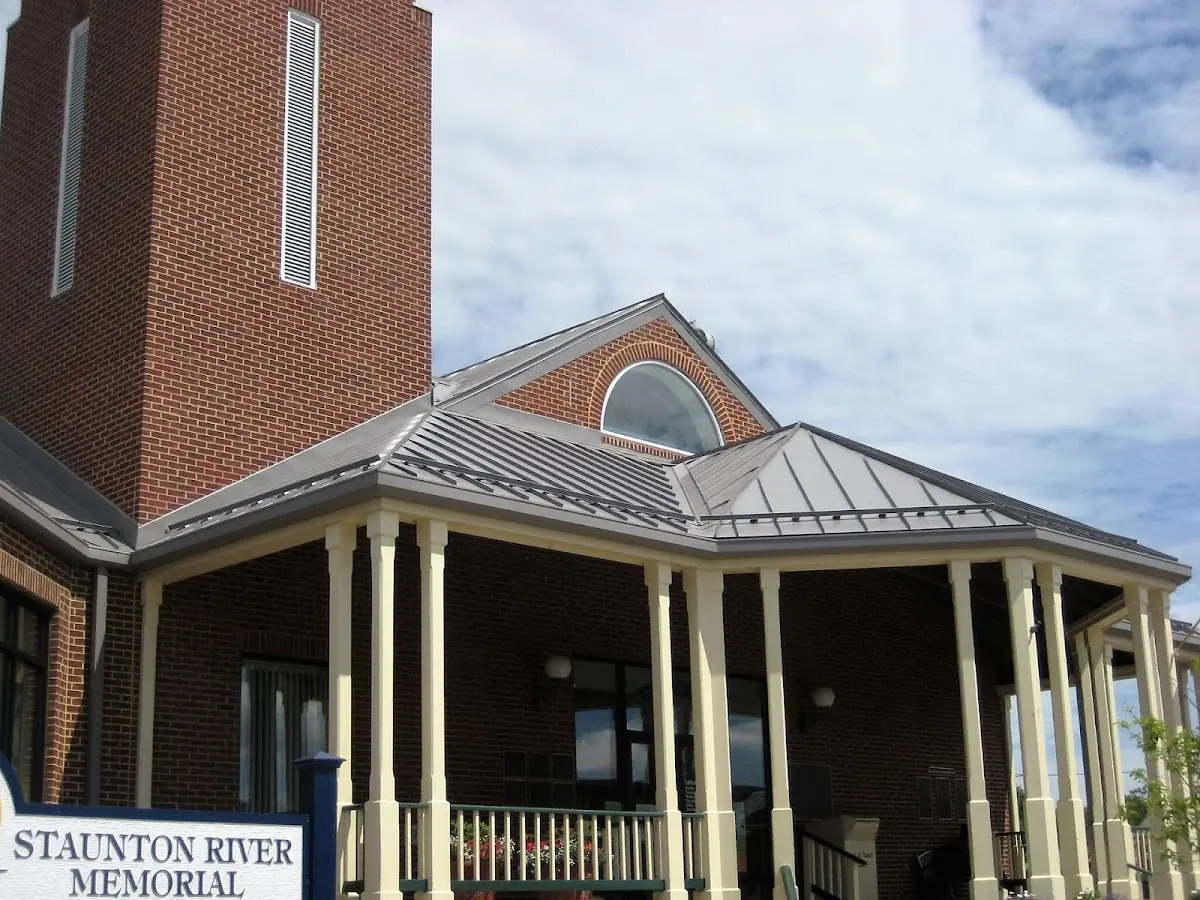 Skilled roofing craftsmen working on a residential roof in Troy